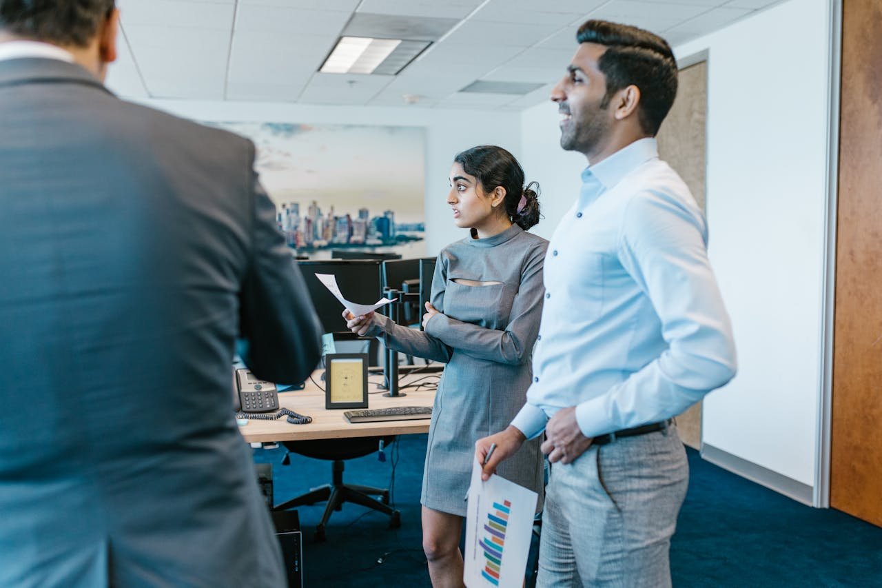 Man in Blue Dress Shirt Standing Beside a Woman